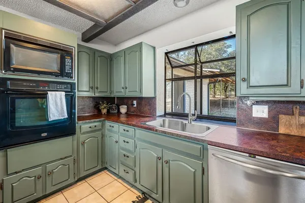 a spacious bedroom with a bed and a chandelier