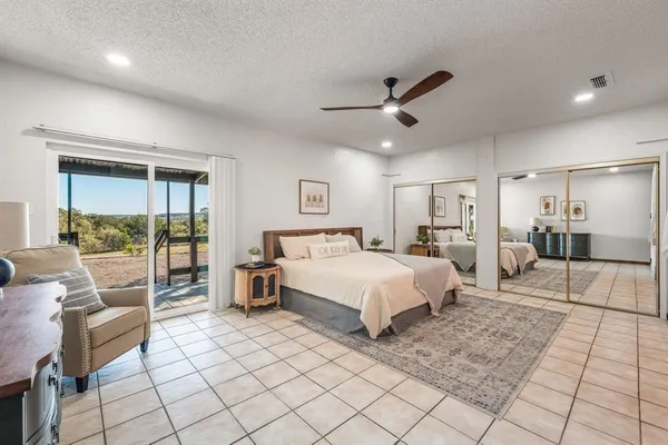 a bedroom with a bed and a view of en suite bathroom