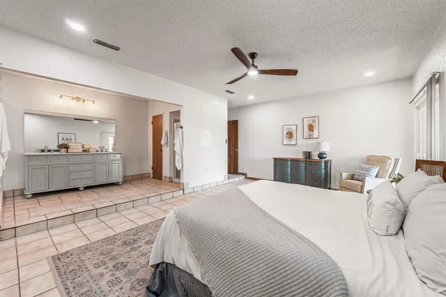 a spacious bathroom with double sink shower and mirror