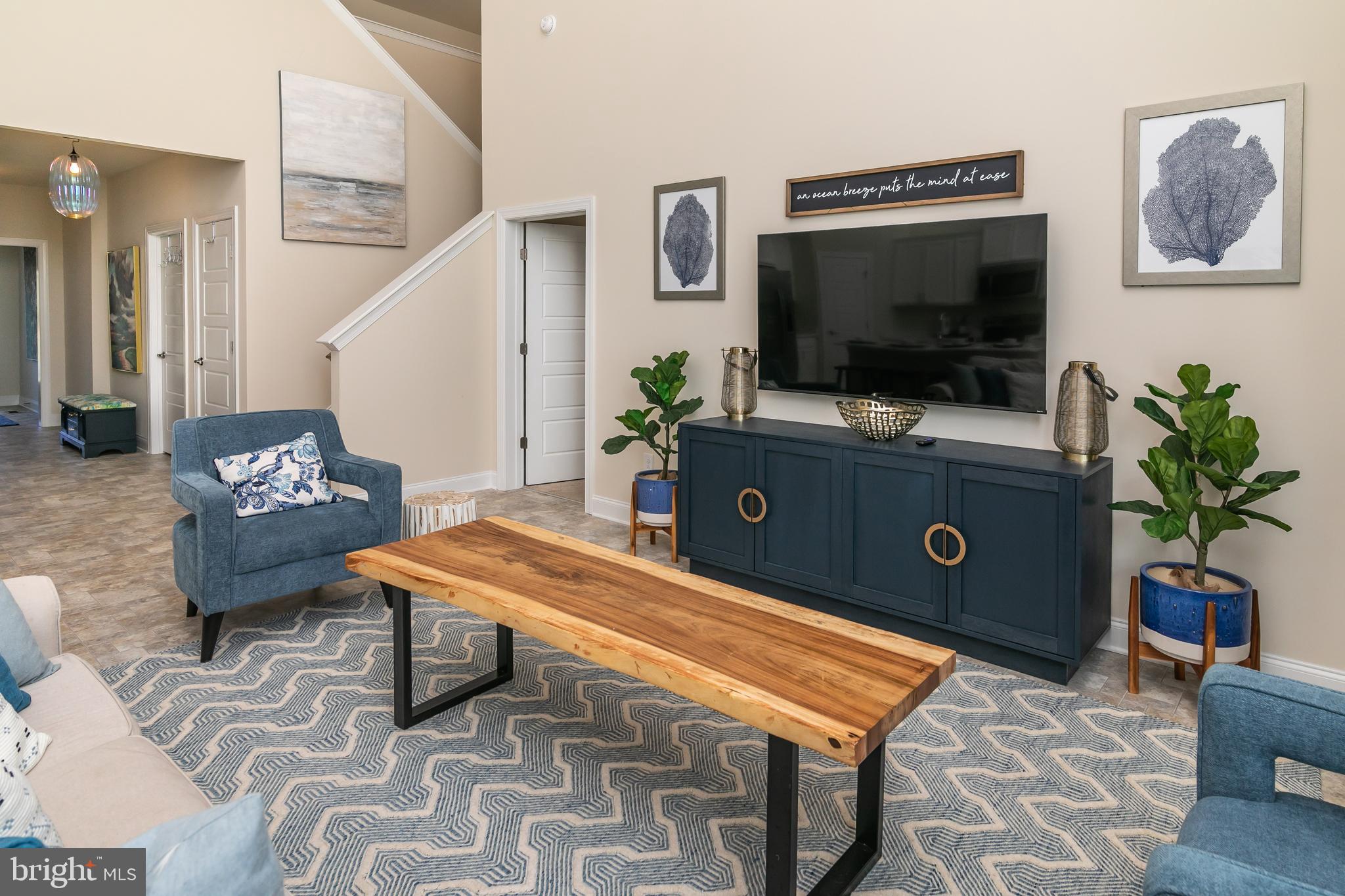 614 Bethany Loop Bethany Beach, DE 19930 - Photo 11 of 92 a living room with furniture and a flat screen tv