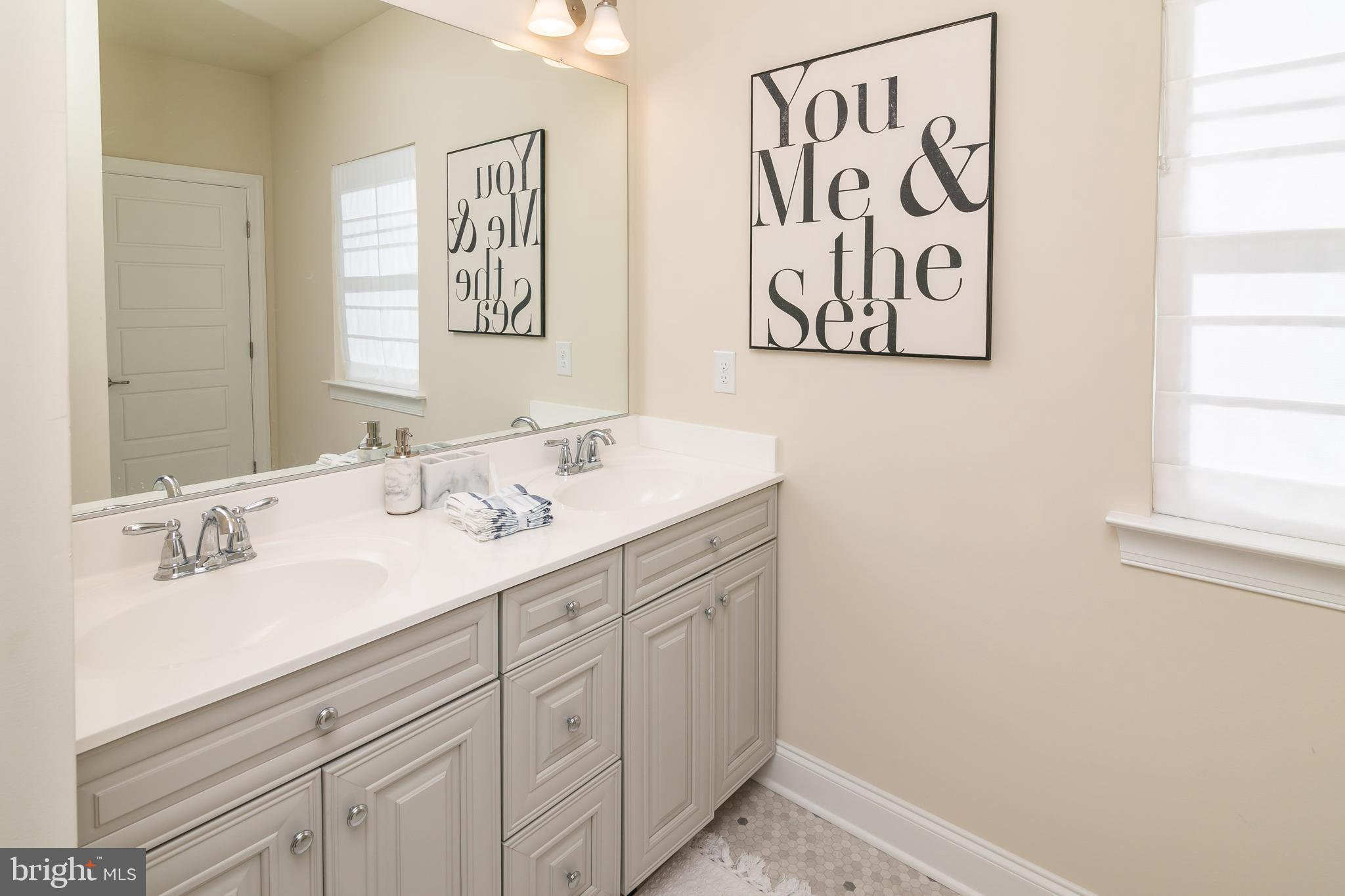 614 Bethany Loop Bethany Beach, DE 19930 - Photo 33 of 92 a bathroom with a sink and a mirror