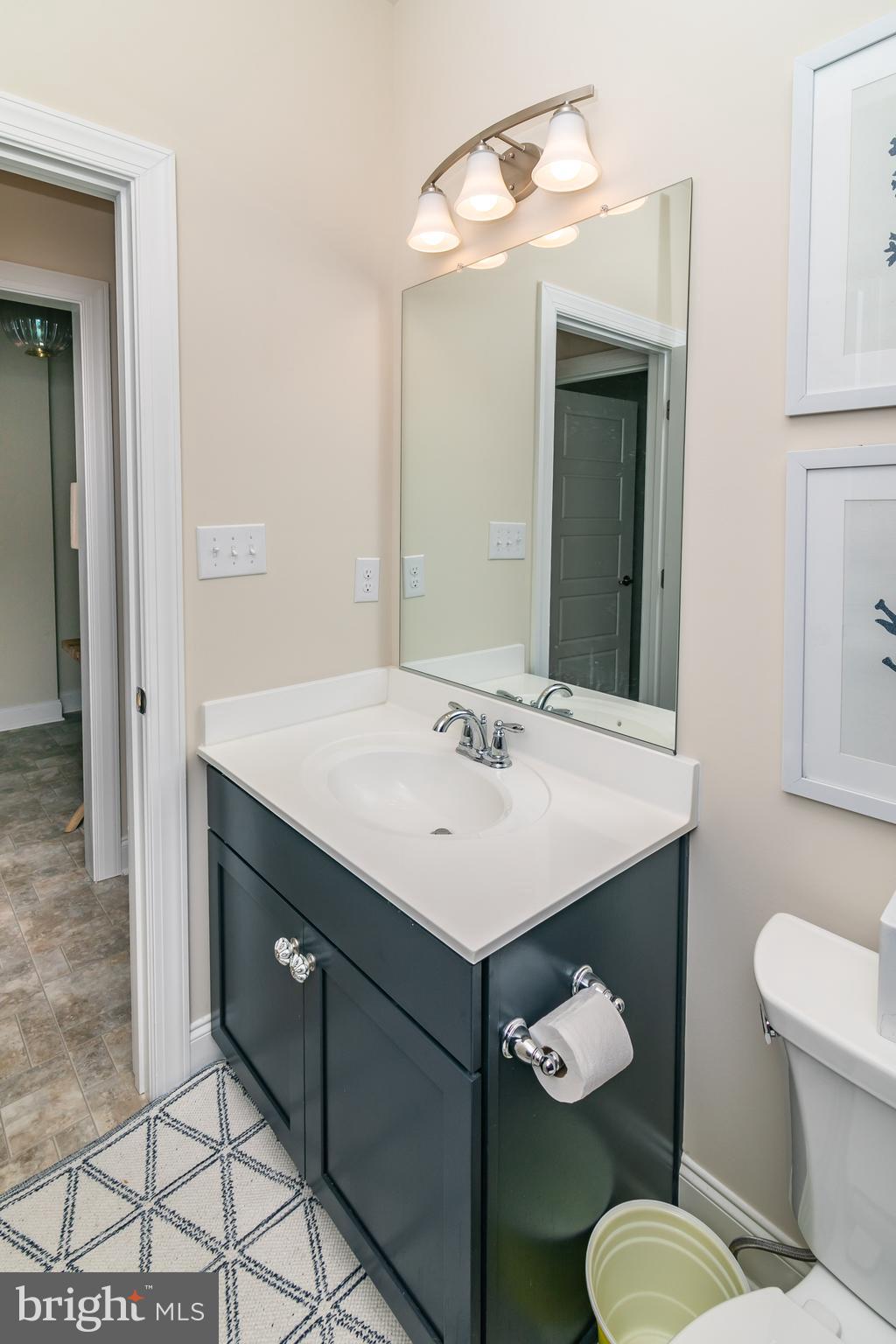 614 Bethany Loop Bethany Beach, DE 19930 - Photo 42 of 92 a bathroom with a sink and a mirror