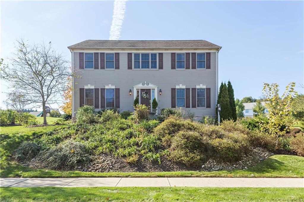 a front view of a house with a yard