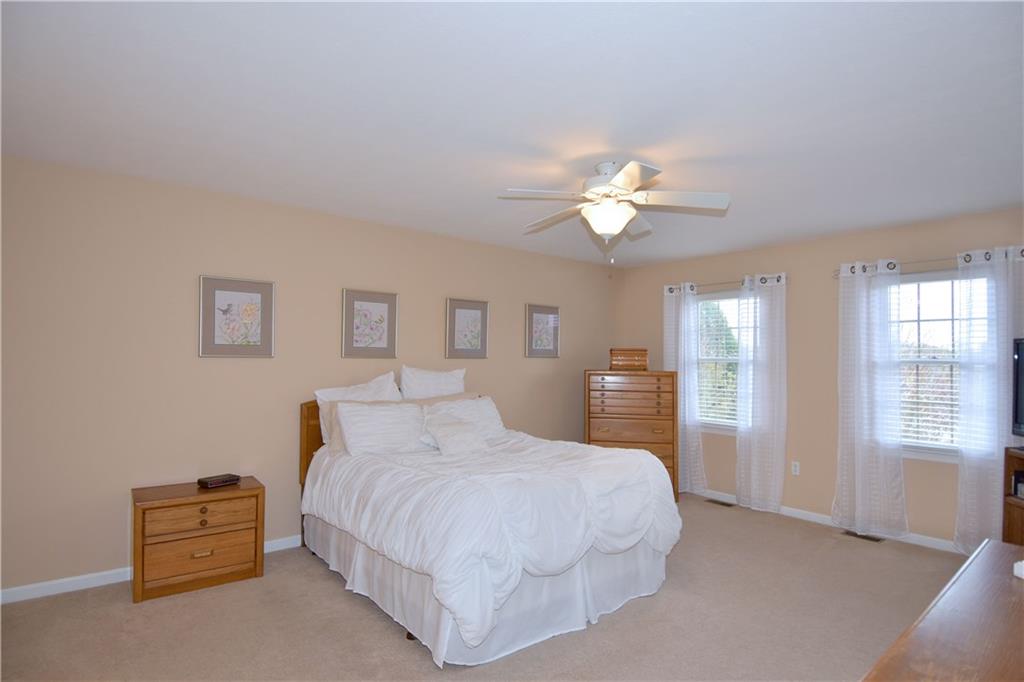 509 Tree Line Drive Gibsonia, PA 15044 - Photo 13 of 25 a spacious bedroom with a bed and a chandelier