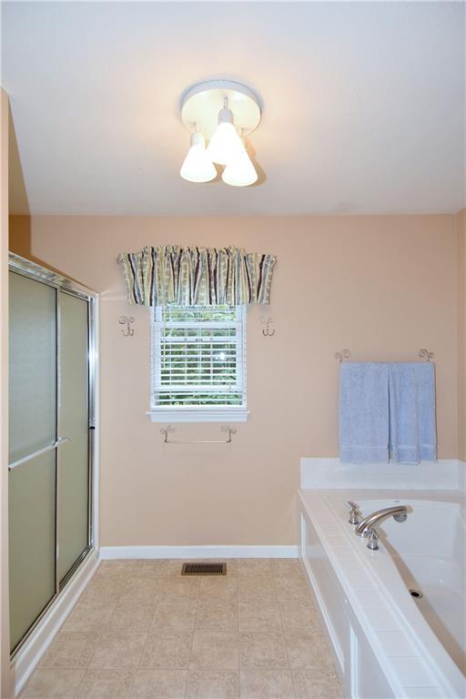 509 Tree Line Drive Gibsonia, PA 15044 - Photo 16 of 25 a bathroom with a tub a sink and a chandelier