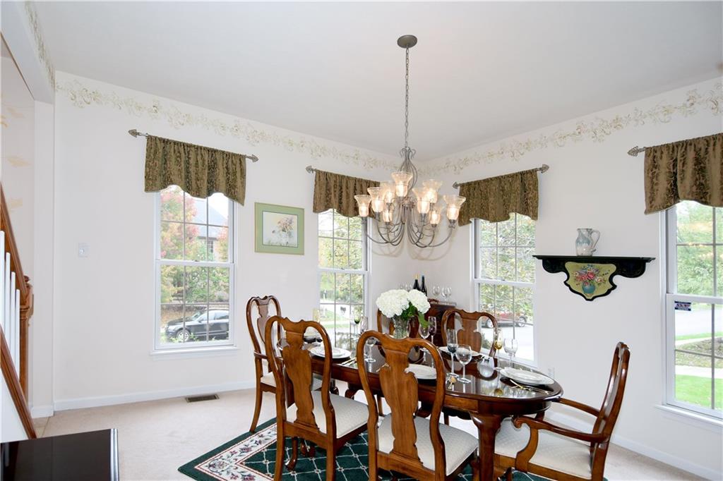 509 Tree Line Drive Gibsonia, PA 15044 - Photo 5 of 25 a view of a dining room with furniture a chandelier and wooden floor