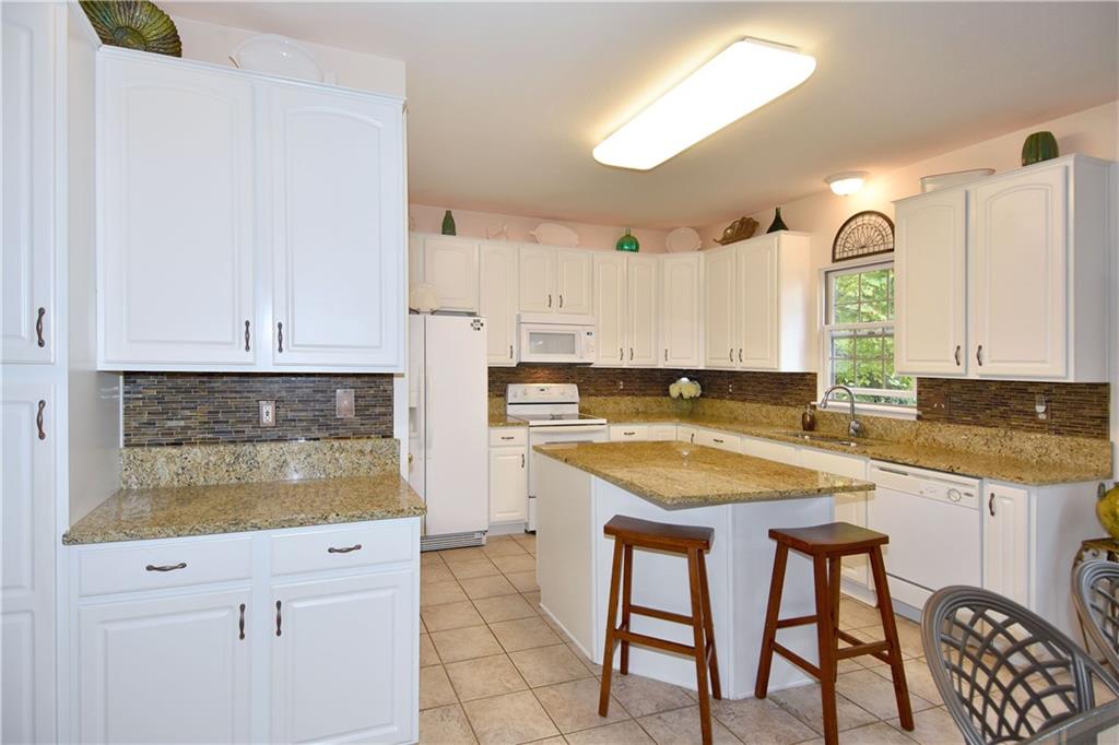 509 Tree Line Drive Gibsonia, PA 15044 - Photo 6 of 25 a kitchen with stainless steel appliances granite countertop a stove a sink and a refrigerator