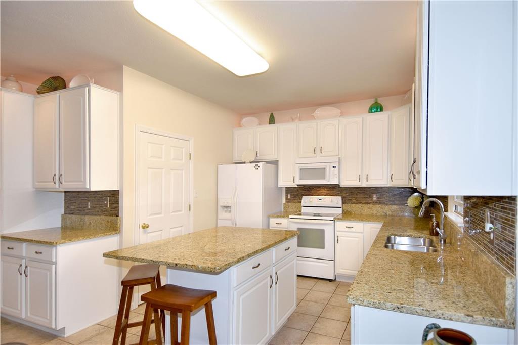 509 Tree Line Drive Gibsonia, PA 15044 - Photo 7 of 25 a kitchen with stainless steel appliances granite countertop a sink stove and refrigerator