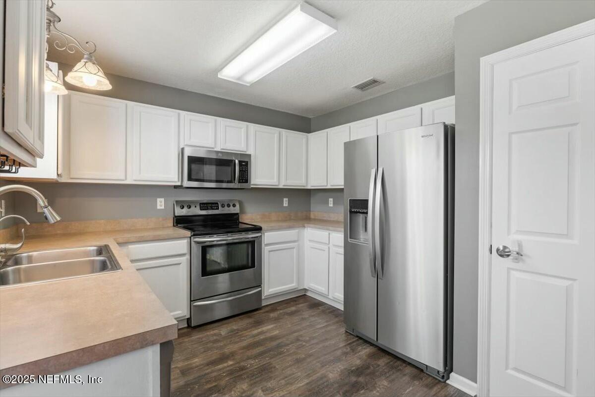 930 Red Fox Way Macclenny, FL 32063 - Photo 13 of 43 a kitchen with a refrigerator sink and microwave