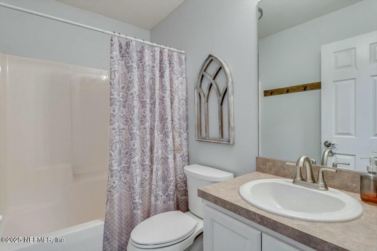 930 Red Fox Way Macclenny, FL 32063 - Photo 23 of 43 a bathroom with a granite countertop sink toilet and shower
