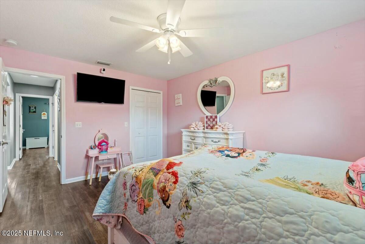 930 Red Fox Way Macclenny, FL 32063 - Photo 27 of 43 a bedroom with a bed and a chandelier