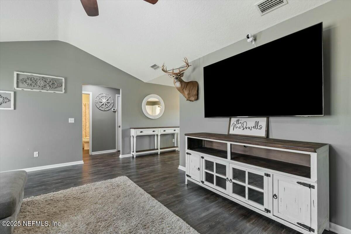 930 Red Fox Way Macclenny, FL 32063 - Photo 8 of 43 a view of a livingroom with furniture and a flat screen tv