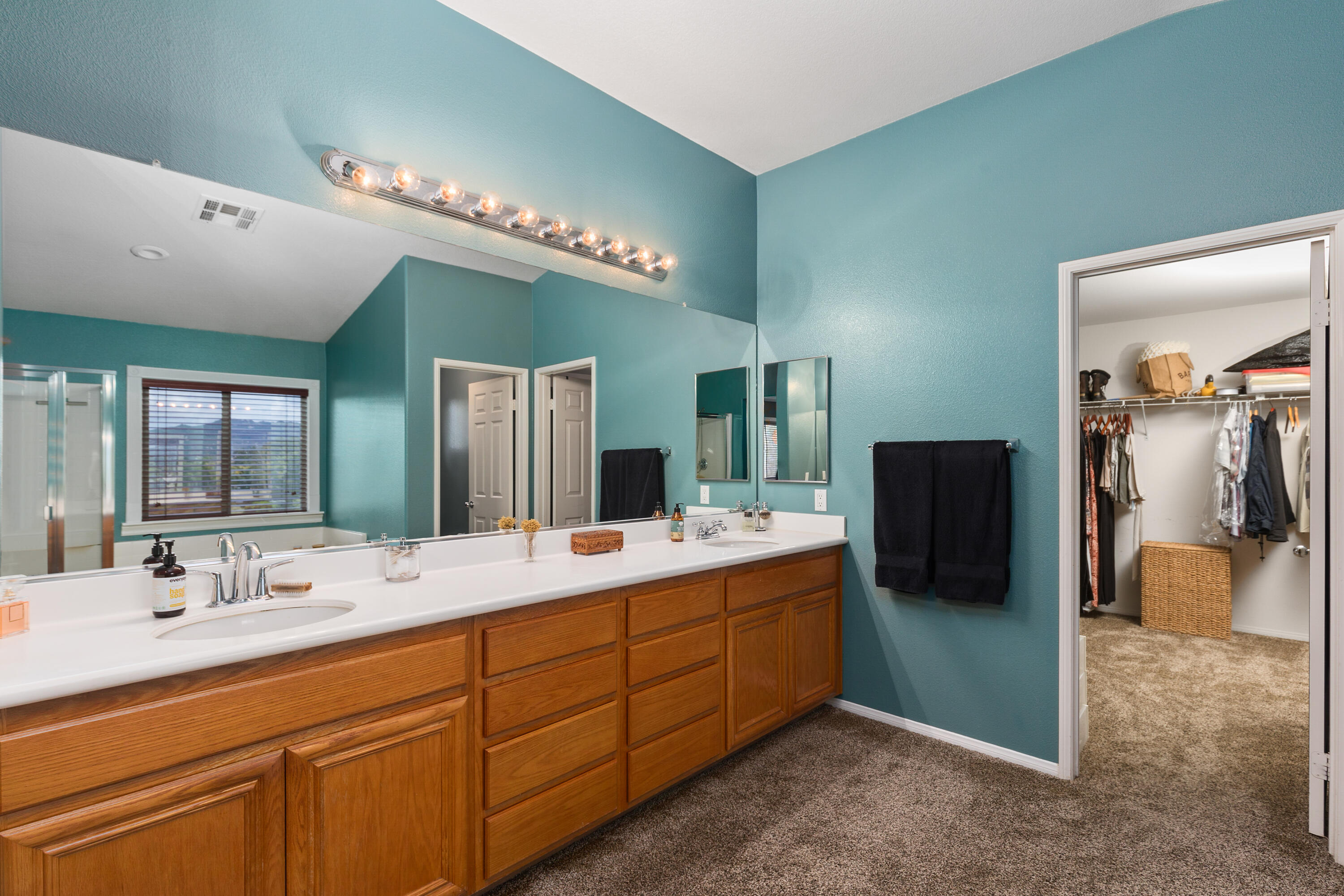 45419 Vanowen Lane Temecula, CA 92592 - Photo 28 of 46 a bathroom with a double vanity sink and a mirror