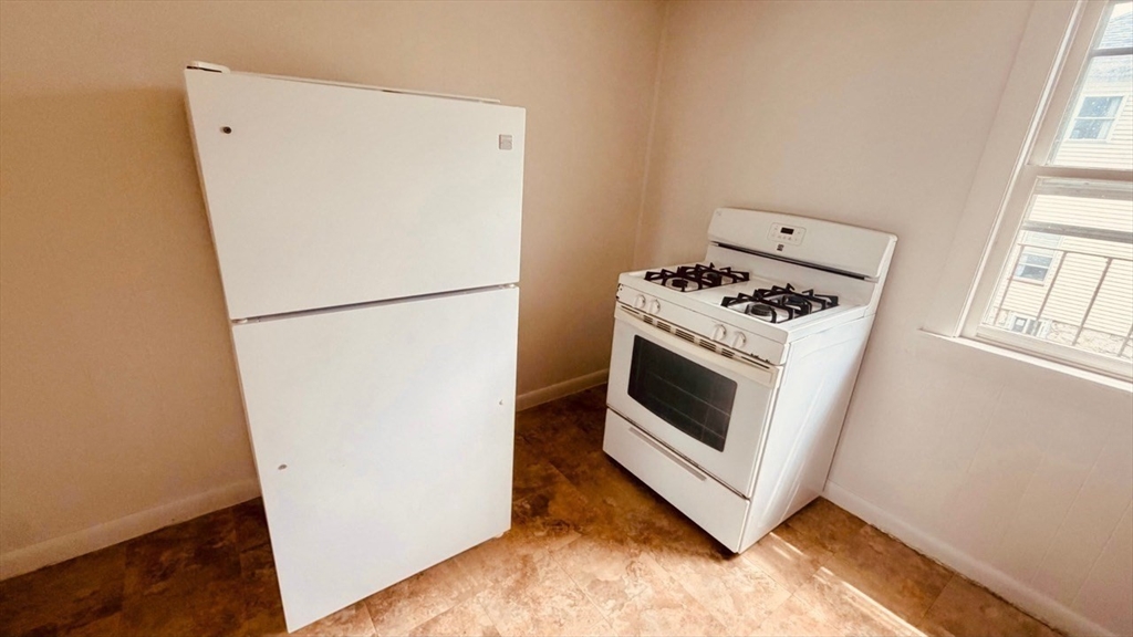 245 County Street, Unit 10 Fall River, MA 02723 - Photo 8 of 9 a white stove top oven sitting inside of a kitchen