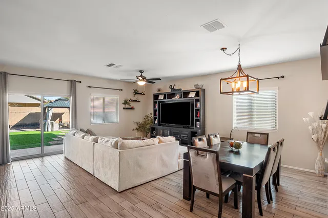 a living room with furniture a wooden floor and a flat screen tv
