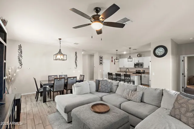 a living room with furniture and a clock
