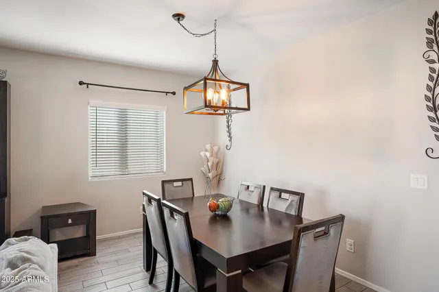a view of a dining room with a table and chairs
