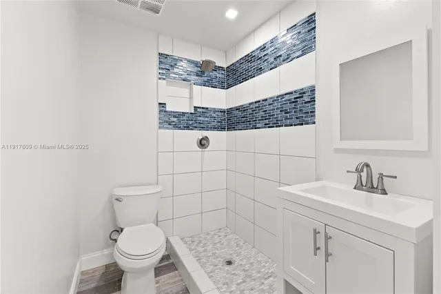 a bathroom with a sink toilet and shower