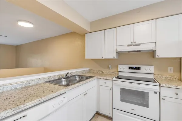 a kitchen with appliances cabinets and a window