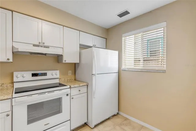a white toilet sitting next to a white sink