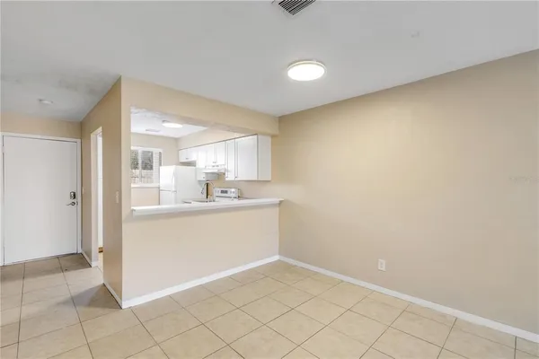 a view of a kitchen with white cabinets