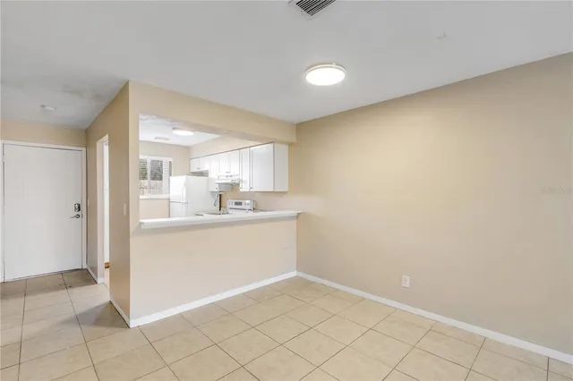 a view of a kitchen with white cabinets