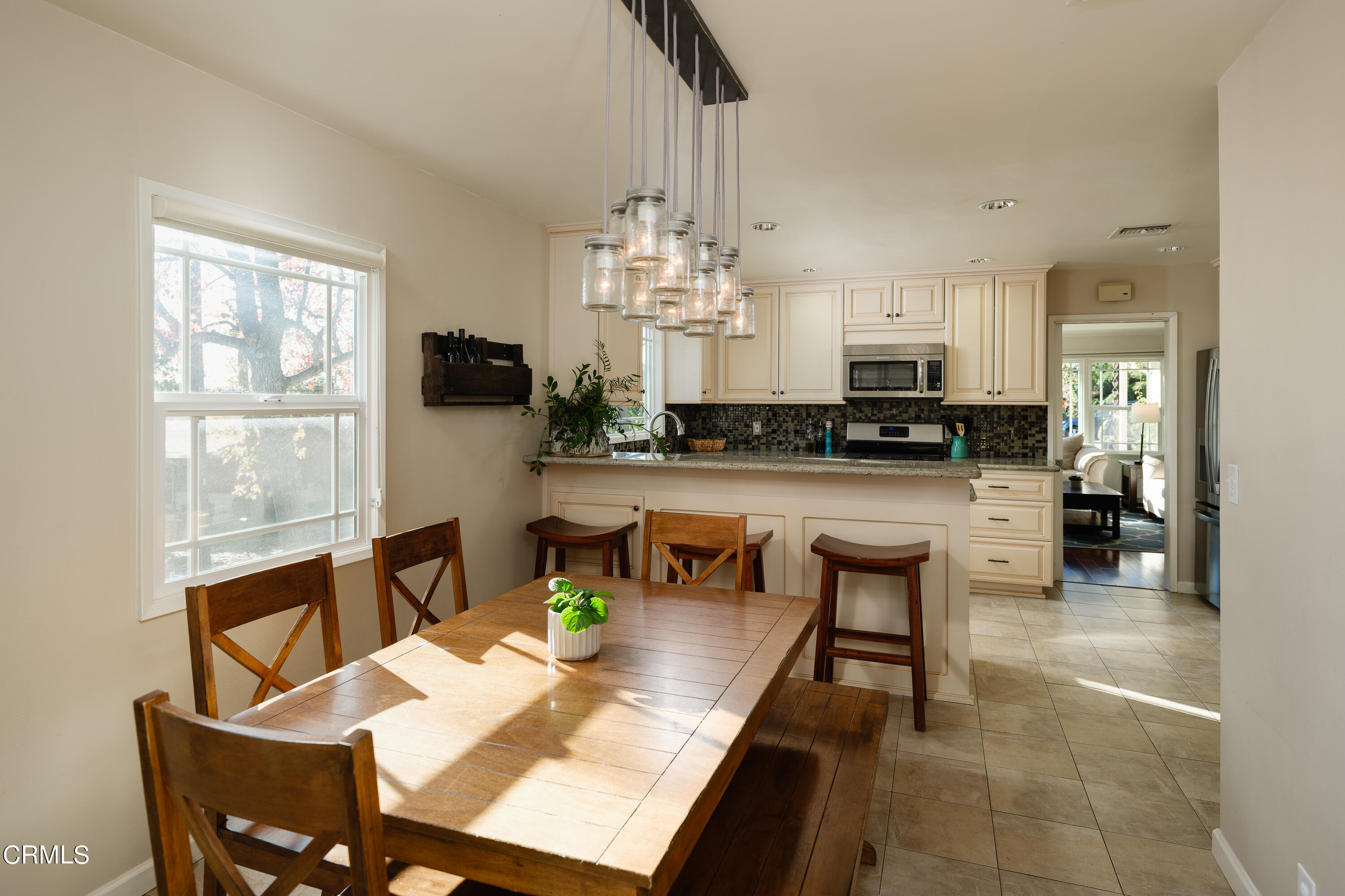 4344 El Prieto Road Altadena, CA 91001 - Photo 11 of 31 a kitchen with kitchen island granite countertop a stove a sink a dining table and chairs