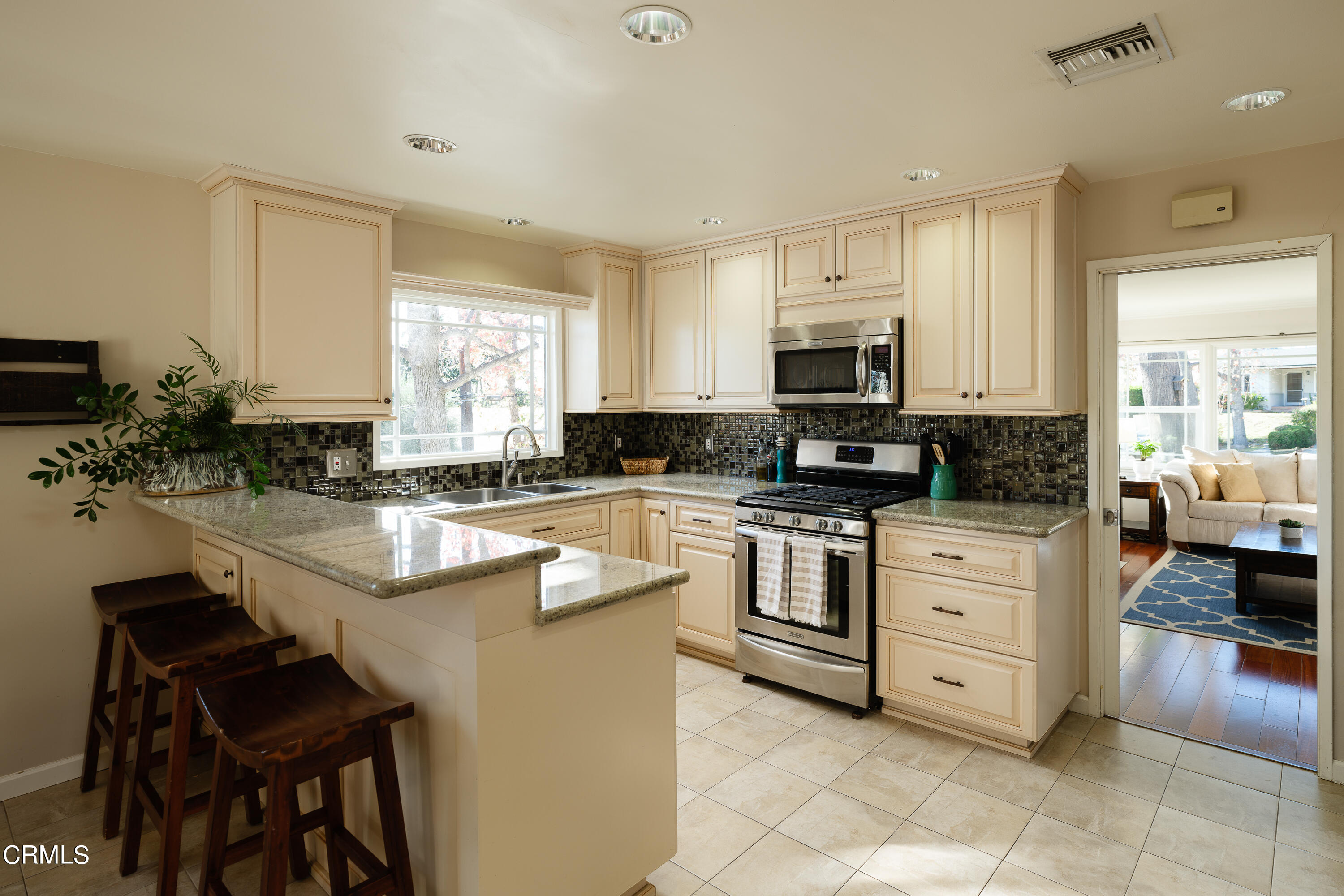 4344 El Prieto Road Altadena, CA 91001 - Photo 7 of 31 a kitchen with granite countertop a stove sink and microwave