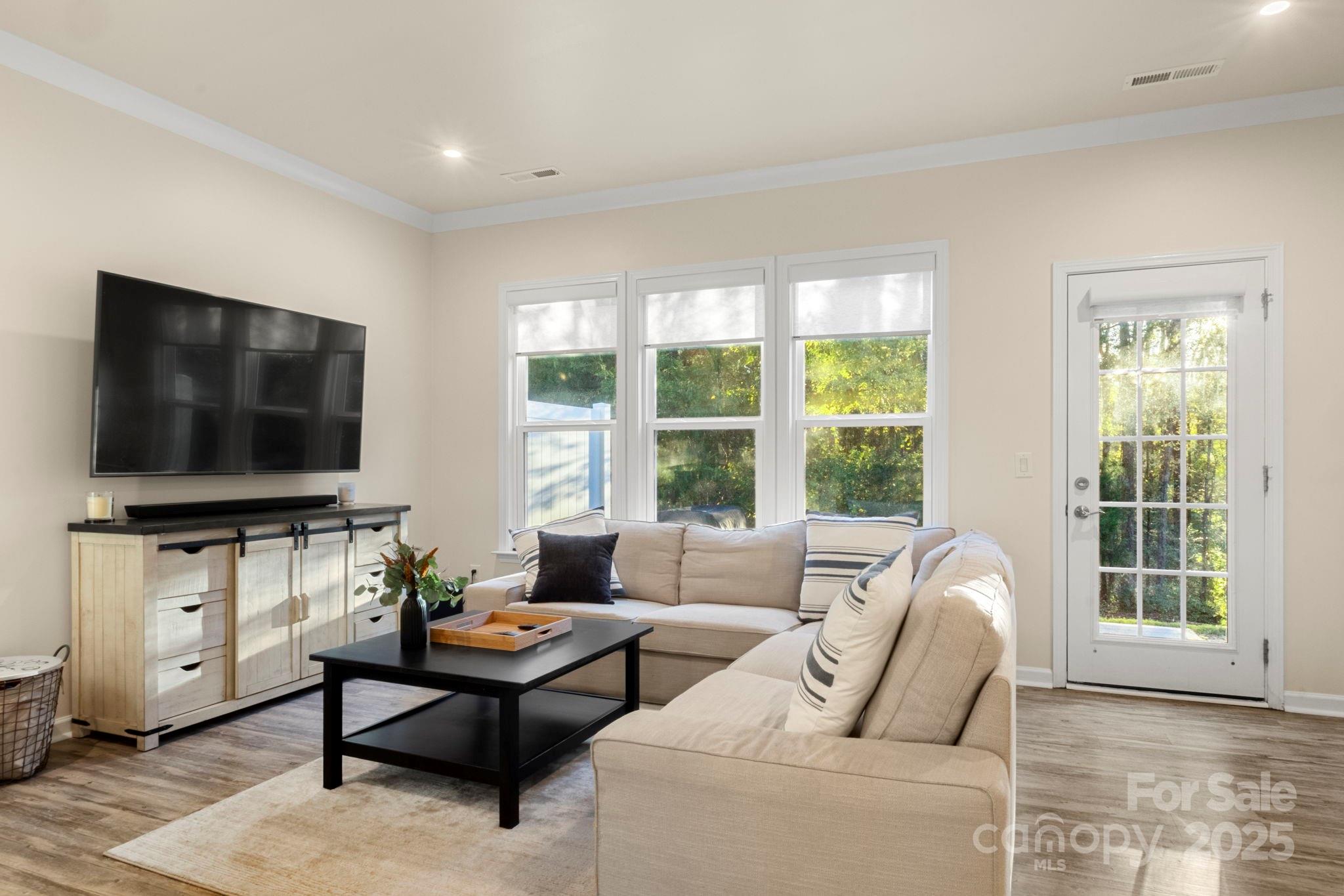 525 Hunters Dance Road Fort Mill, SC 29708 - Photo 11 of 28 a living room with furniture a flat screen tv and a large window