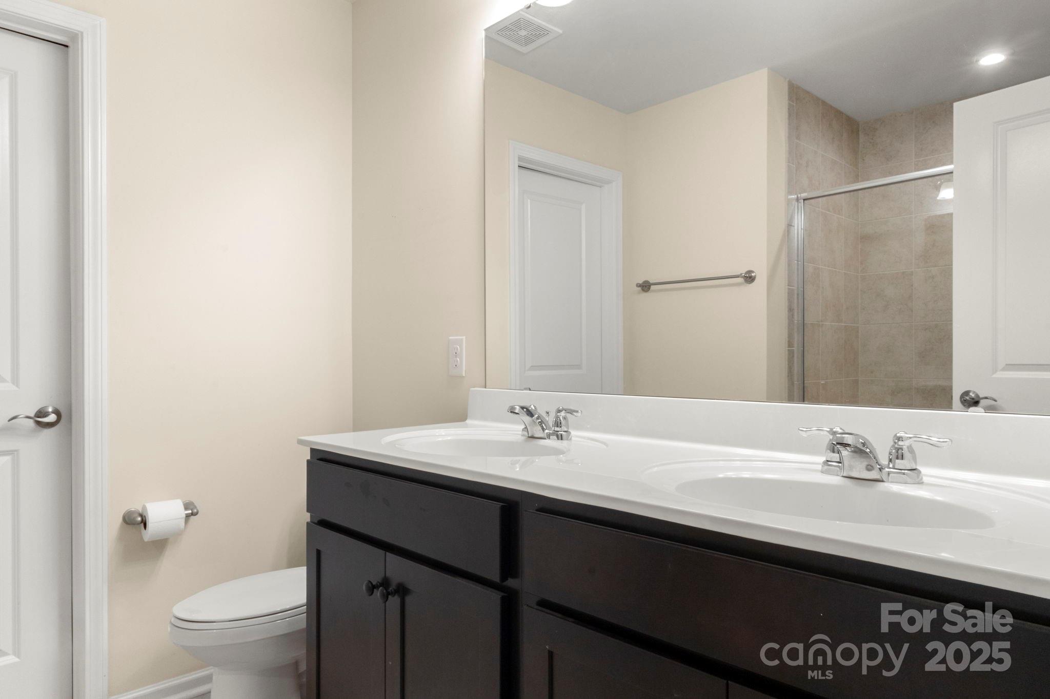 525 Hunters Dance Road Fort Mill, SC 29708 - Photo 17 of 28 a bathroom with a sink a toilet a shower and a mirror