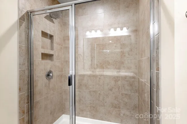 a bathroom with a glass shower door