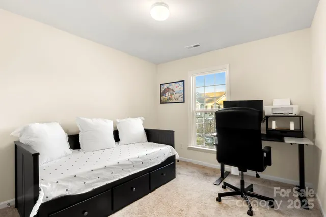 a bedroom with a bed and a desk