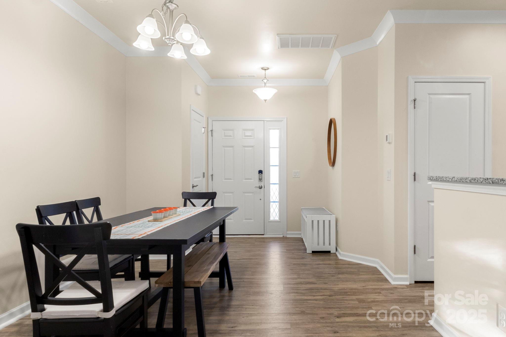 525 Hunters Dance Road Fort Mill, SC 29708 - Photo 3 of 28 a view of a dining room with furniture and wooden floor