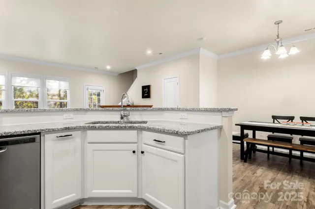 a kitchen with granite countertop white cabinets and appliances