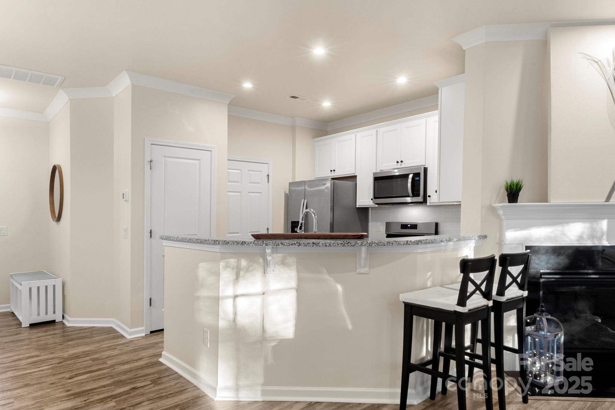 525 Hunters Dance Road Fort Mill, SC 29708 - Photo 7 of 28 a kitchen with stainless steel appliances granite countertop a stove a sink a microwave a refrigerator and cabinets