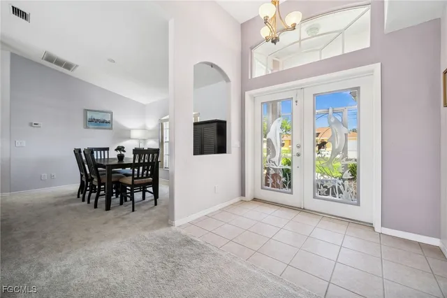 a dining room with furniture a chandelier and a rug