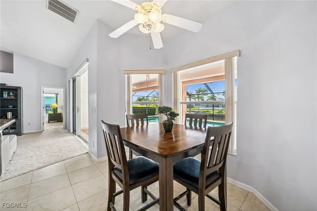 a spacious bedroom with a bed and a chandelier