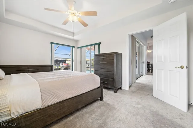 a bedroom with a bed lamp and a large window