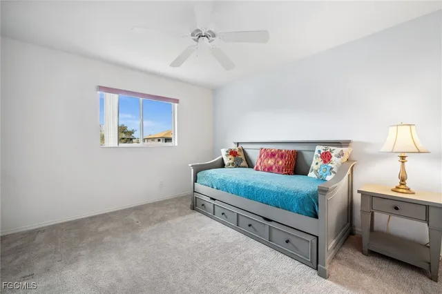 a bedroom with a bed and a flat tv screen on a dresser