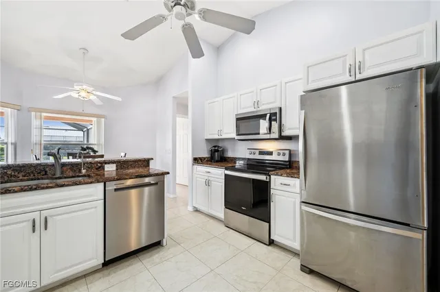 a kitchen with a appliances a sink and cabinets