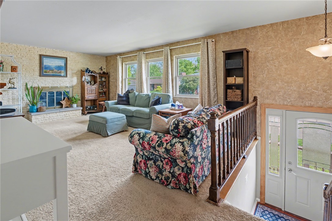 4919 Silver Arrow Drive Riverside, OH 45424 - Photo 7 of 57 This inviting living room offers abundant natural light and a charming fireplace feature.