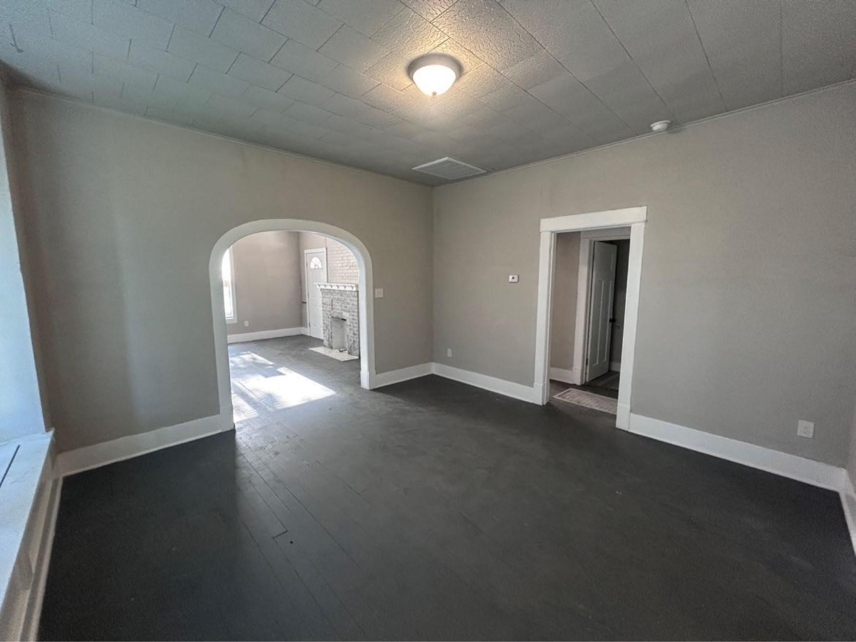 1925 11th Street Port Arthur, TX 77640 - Photo 11 of 28 an empty room with wooden floor and windows