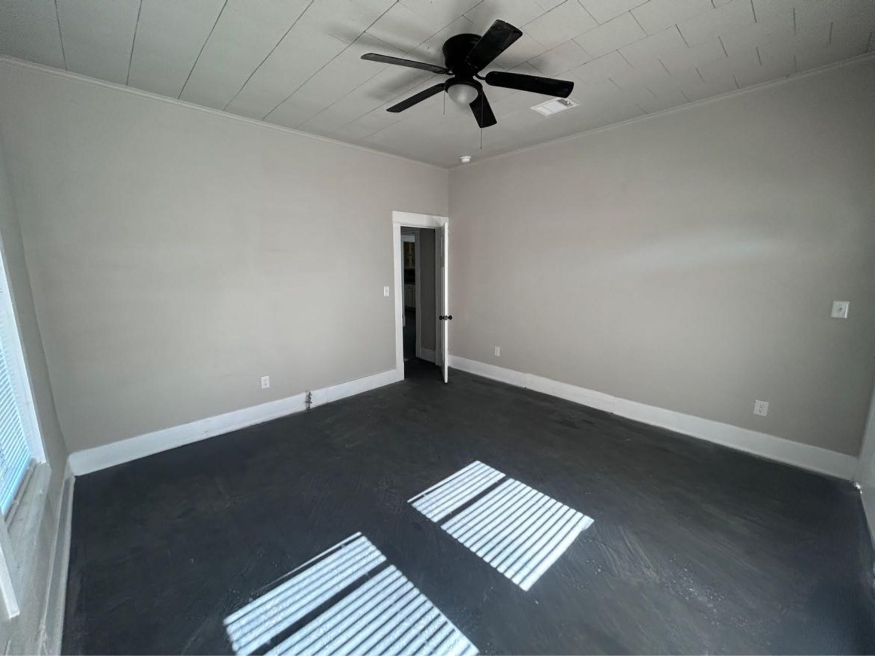 1925 11th Street Port Arthur, TX 77640 - Photo 15 of 28 an empty room with wooden floor and windows
