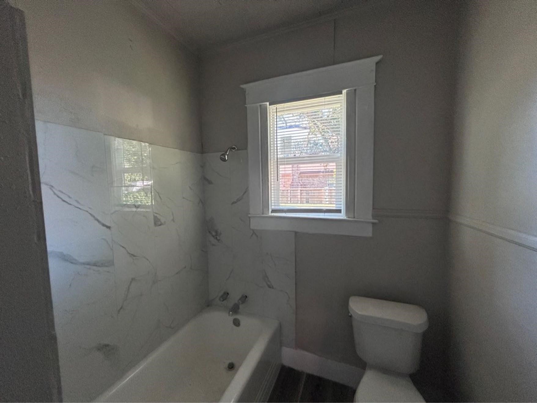 1925 11th Street Port Arthur, TX 77640 - Photo 20 of 28 a bathroom with a toilet sink and bathtub