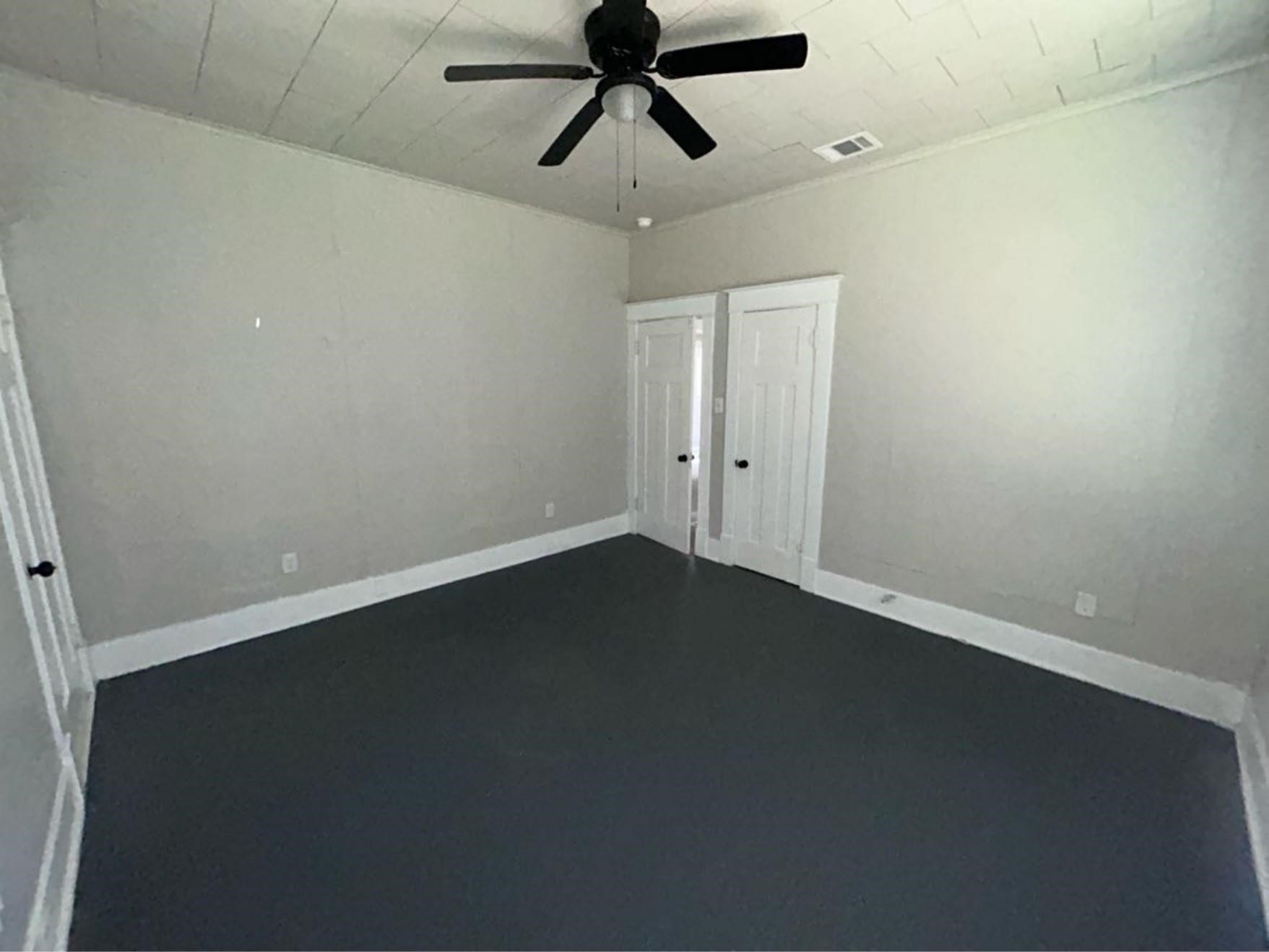 1925 11th Street Port Arthur, TX 77640 - Photo 22 of 28 an empty room with a ceiling fan and a window