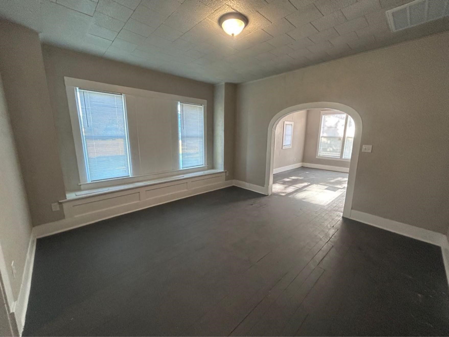 1925 11th Street Port Arthur, TX 77640 - Photo 3 of 28 an empty room with wooden floor and windows