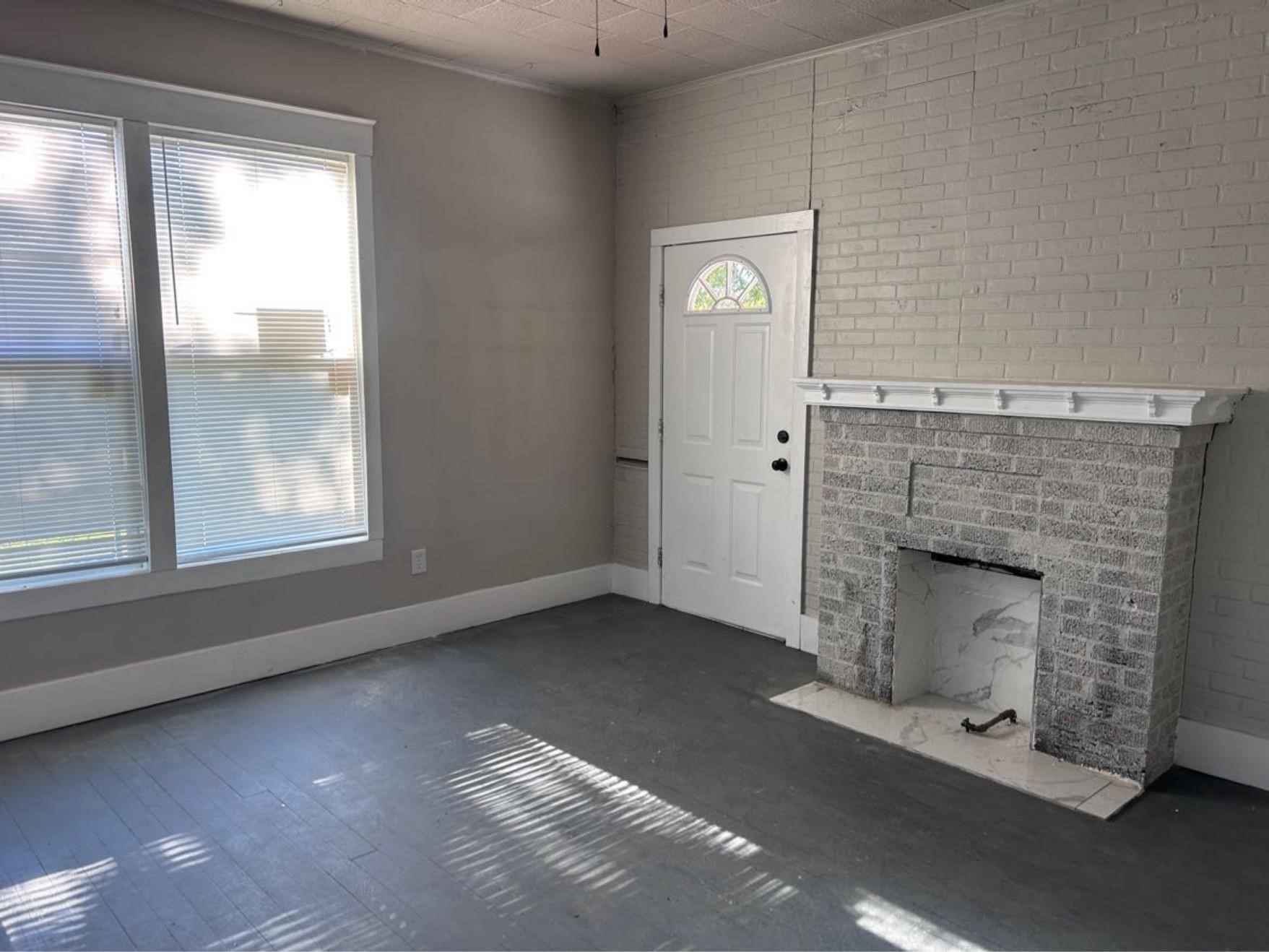 1925 11th Street Port Arthur, TX 77640 - Photo 4 of 28 an empty room with windows and fireplace