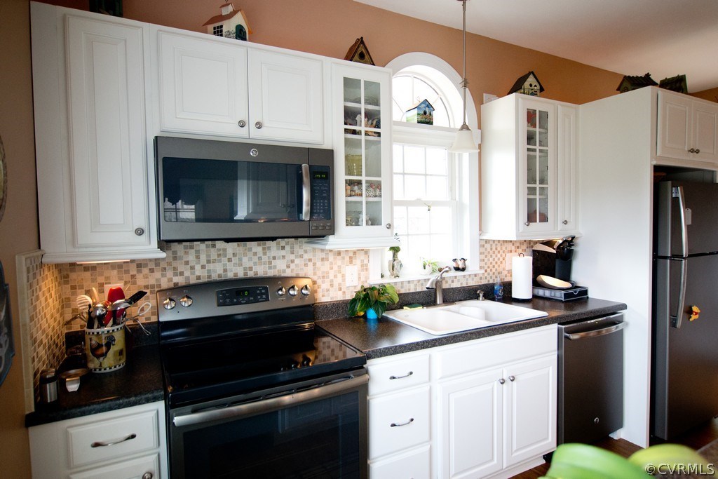 301 Slaughter Road Keysville, VA 23947 - Photo 11 of 50 a kitchen with stainless steel appliances a stove a microwave and cabinets