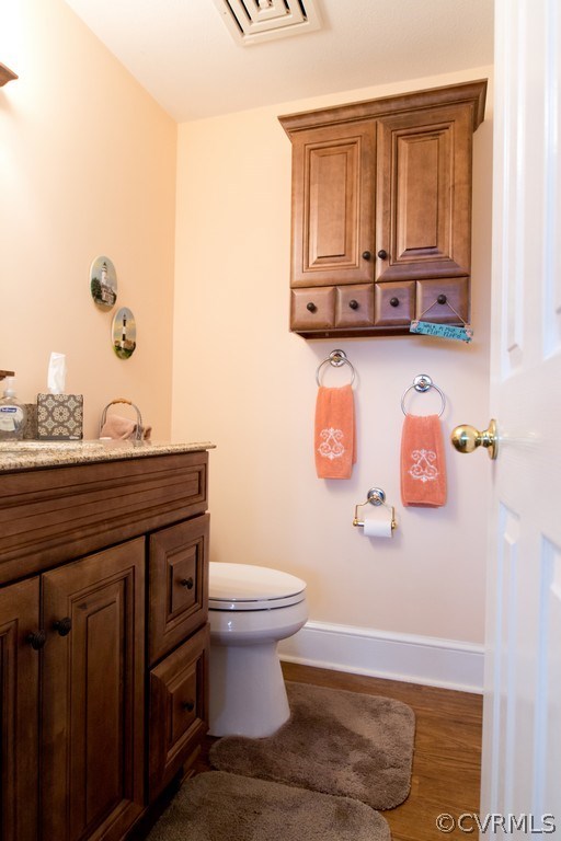301 Slaughter Road Keysville, VA 23947 - Photo 13 of 50 a bathroom with a granite countertop toilet sink and mirror