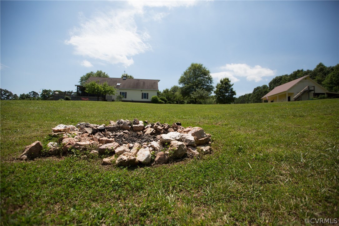 301 Slaughter Road Keysville, VA 23947 - Photo 40 of 50 a front view of a house with a garden and lake view